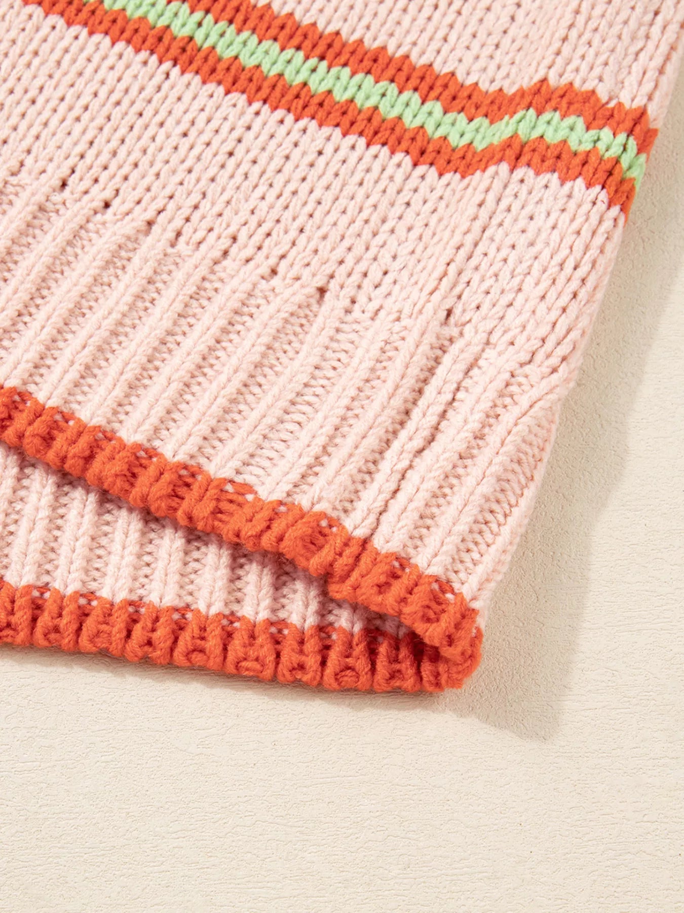 Multicolor striped knit cardigan with ribbed cuffs styled over a white tank and jeans