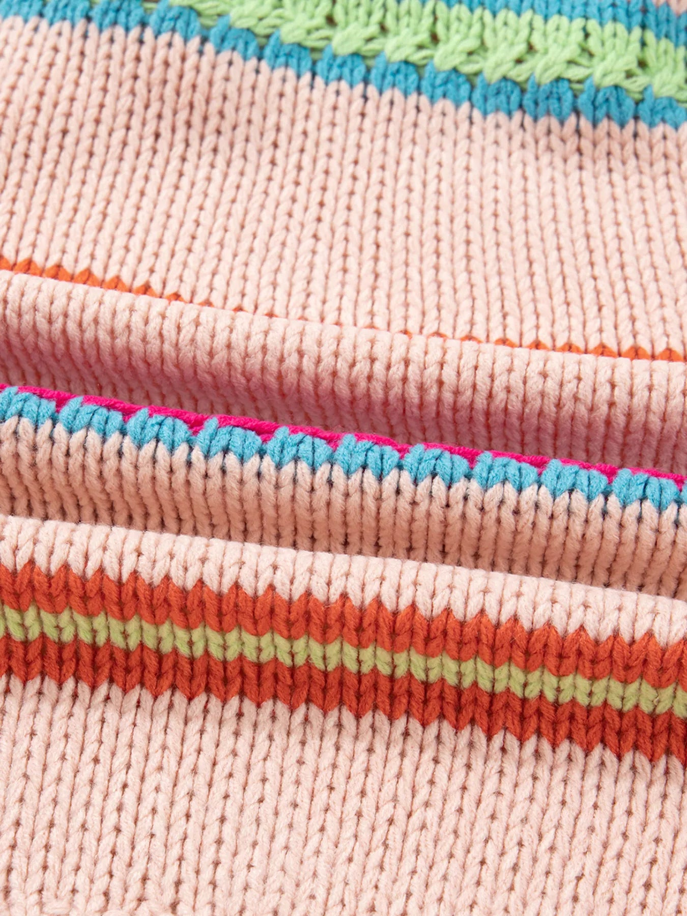 Multicolor striped knit cardigan with ribbed cuffs styled over a white tank and jeans