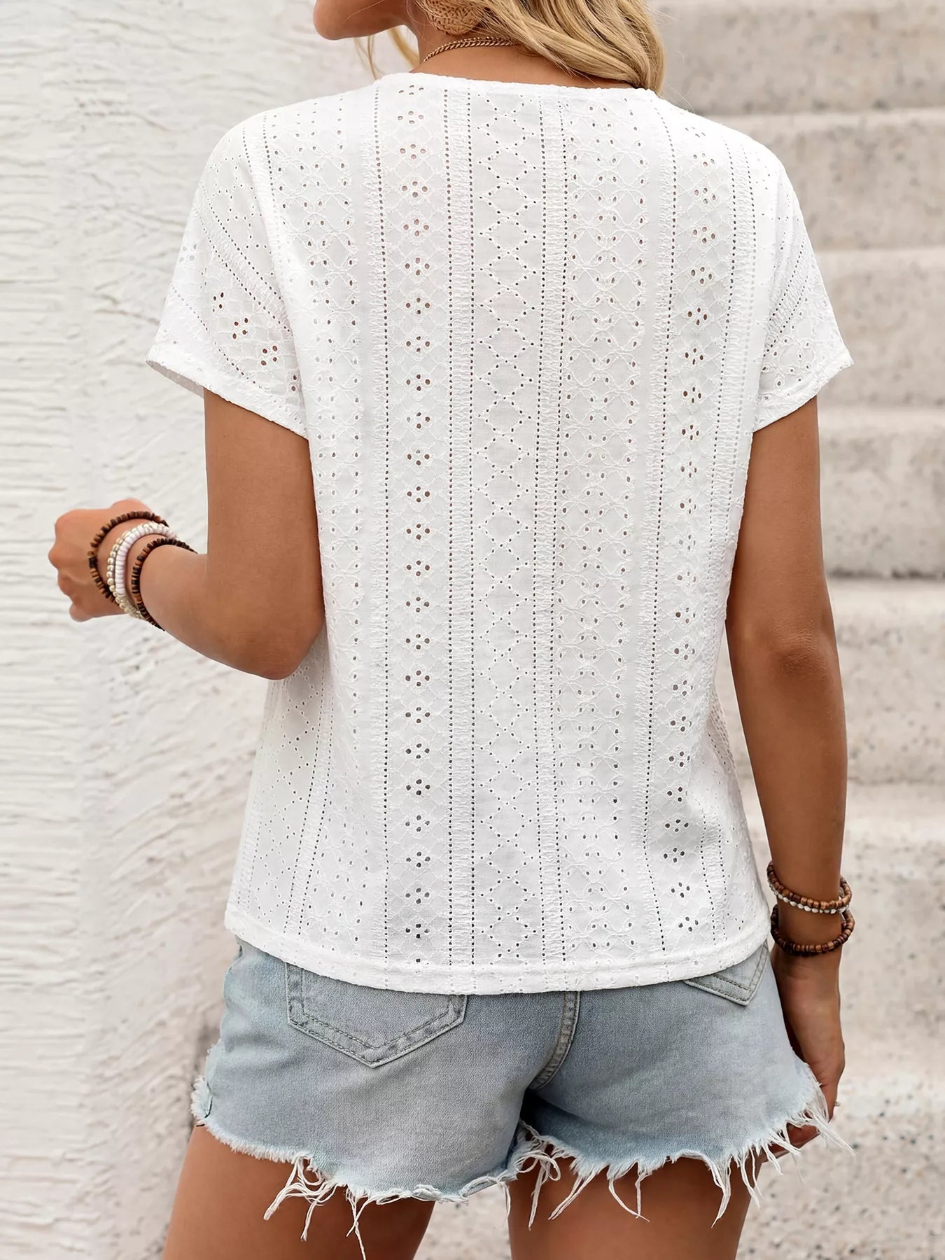 White eyelet short sleeve top with multicolor embroidered V-neck
