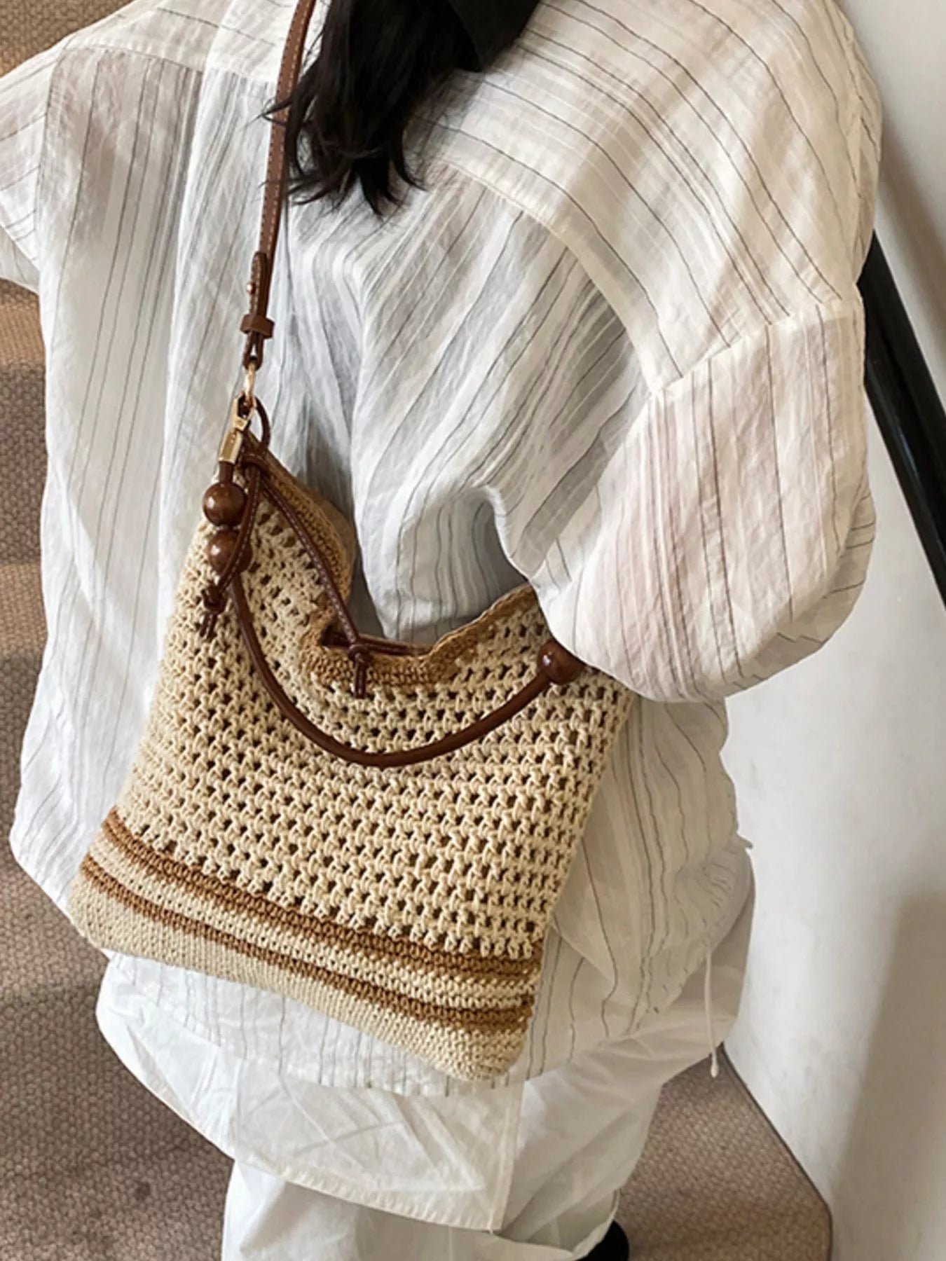 Medium woven boho shoulder bag with crochet-style texture, beaded accents, brown strap details, and lightweight polyester material.
