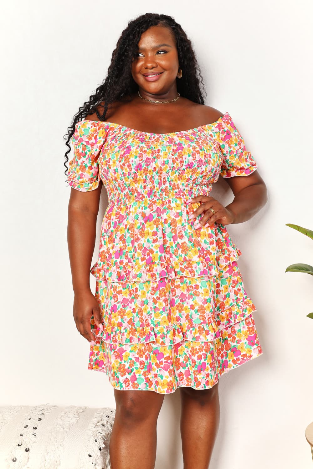 Colorful floral smocked mini dress with sweetheart neckline and tiered skirt