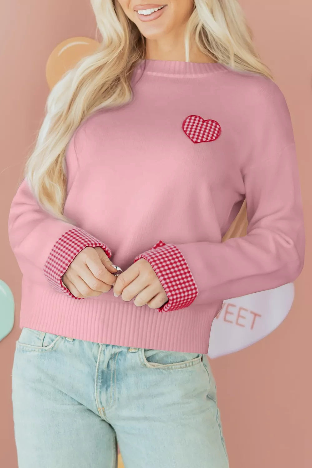 Blush pink knit sweater with embroidered gingham heart and gingham cuff details