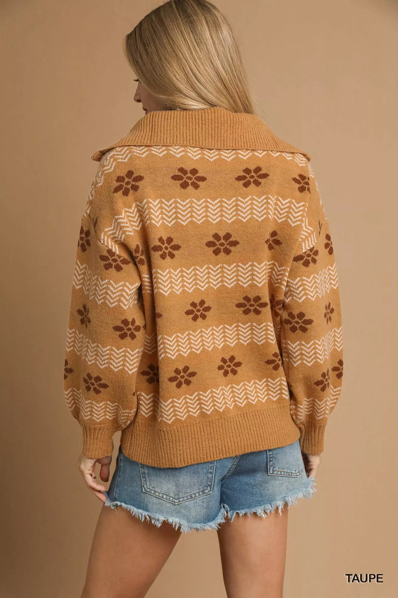 Model wearing a taupe floral jacquard quarter-zip sweater with ribbed cuffs and hem, styled in a soft neutral palette for a cozy vintage look.