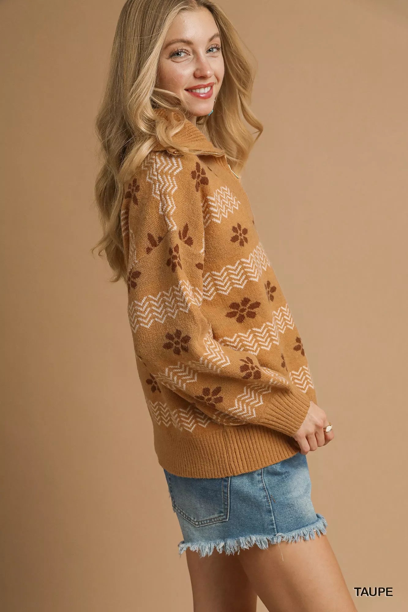 Model wearing a taupe floral jacquard quarter-zip sweater with ribbed cuffs and hem, styled in a soft neutral palette for a cozy vintage look.