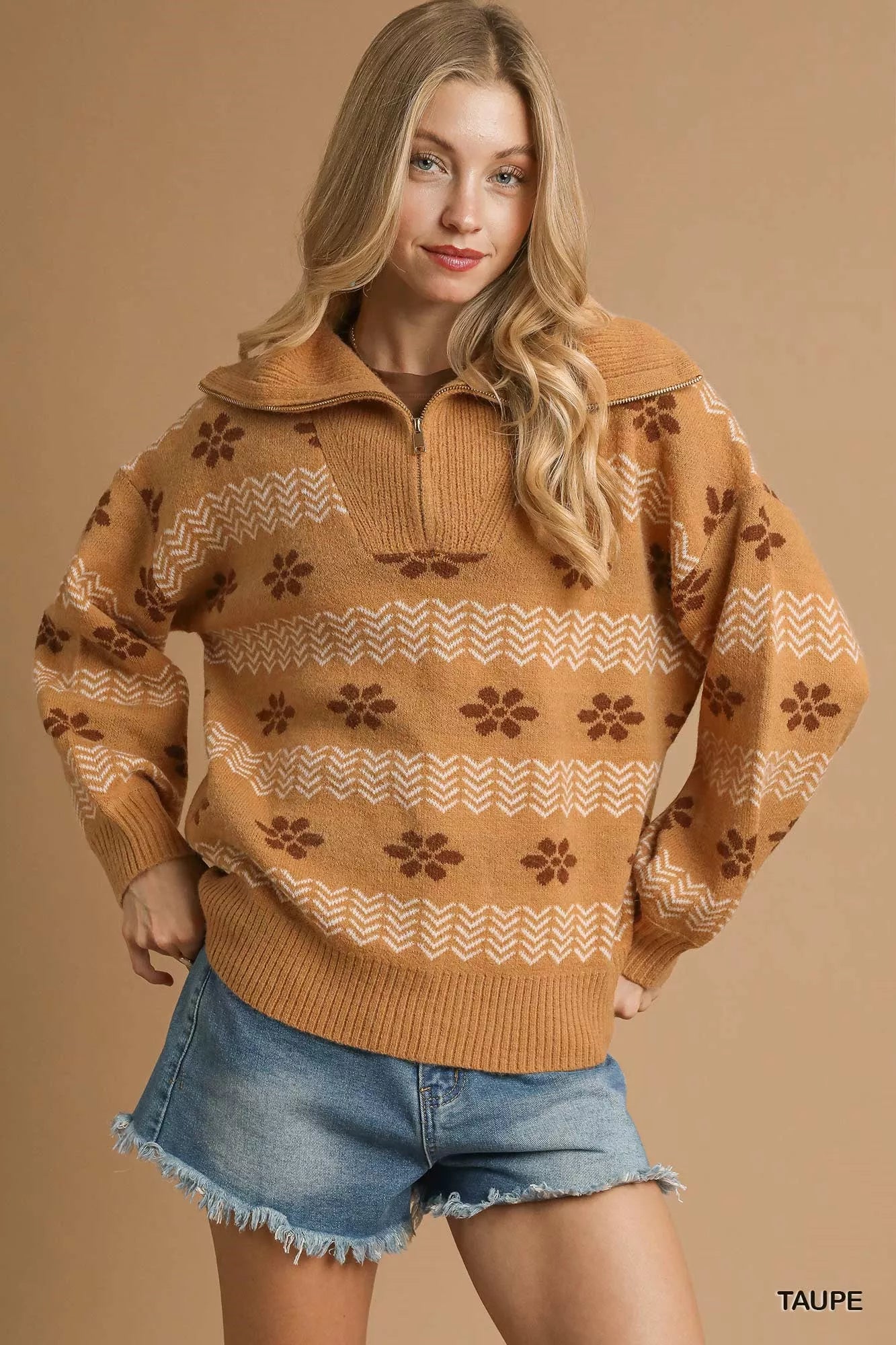 Model wearing a taupe floral jacquard quarter-zip sweater with ribbed cuffs and hem, styled in a soft neutral palette for a cozy vintage look.