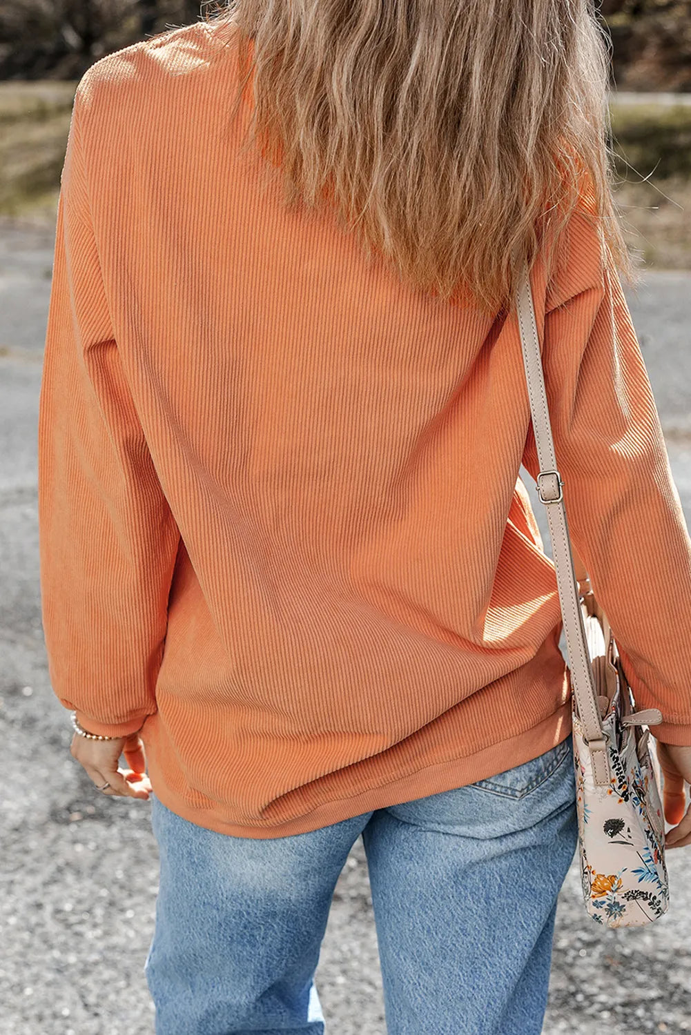 Woman wearing an orange corduroy pullover with the word “thankful.” printed across the chest — cozy fall sweatshirt from A Whimsical Affair.