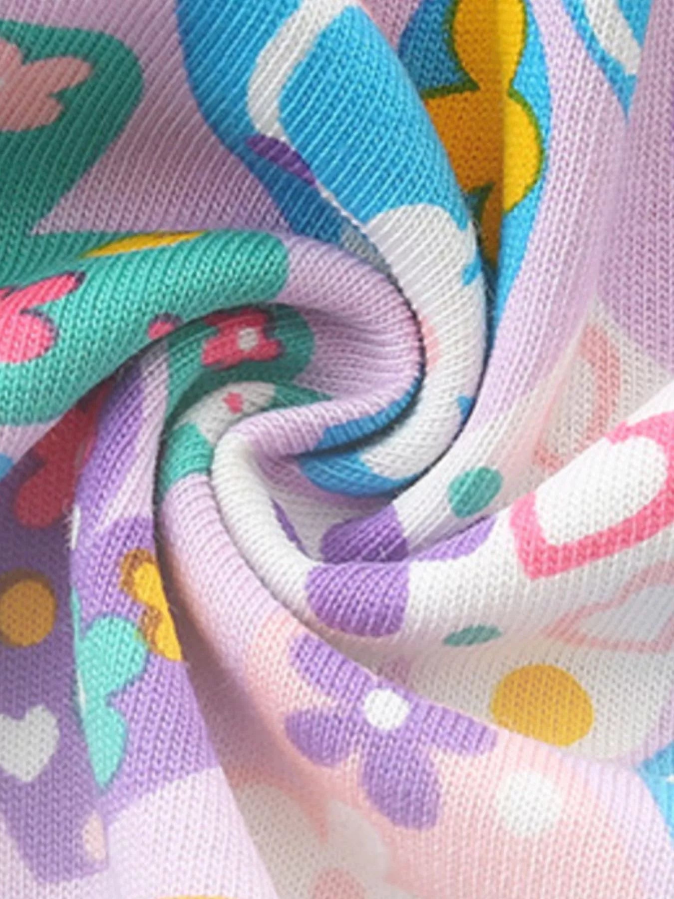 Girls cotton dress with colorful paisley floral print, purple trim, flutter sleeves, and heart-shaped front pockets.