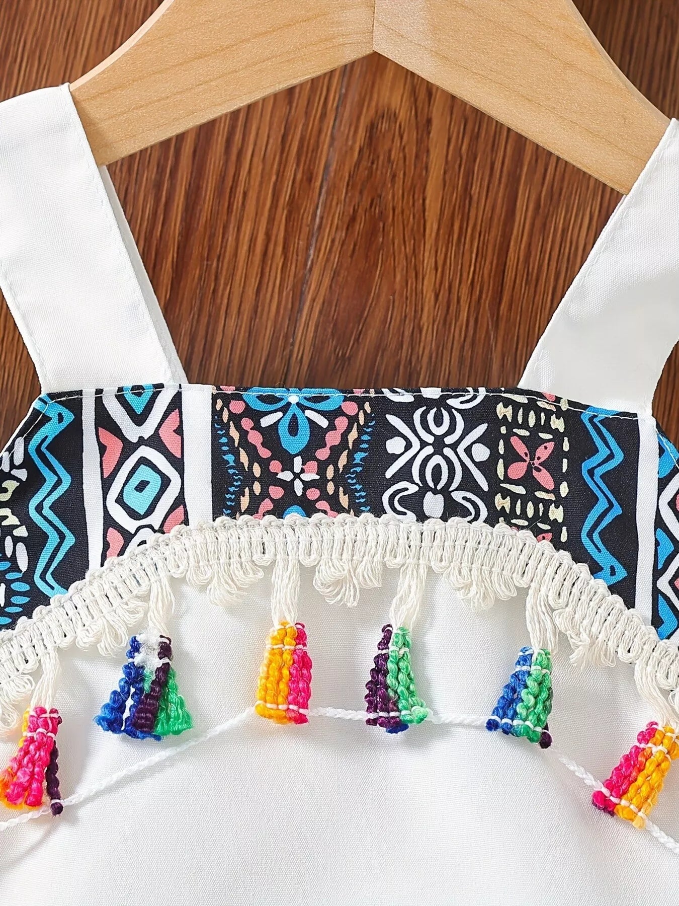 Children’s two-piece boho outfit with tassel crop top, printed wide-leg pants, pockets, and colorful summer styling.
