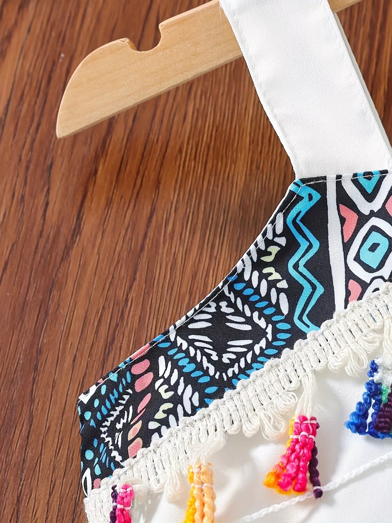 Children’s two-piece boho outfit with tassel crop top, printed wide-leg pants, pockets, and colorful summer styling.