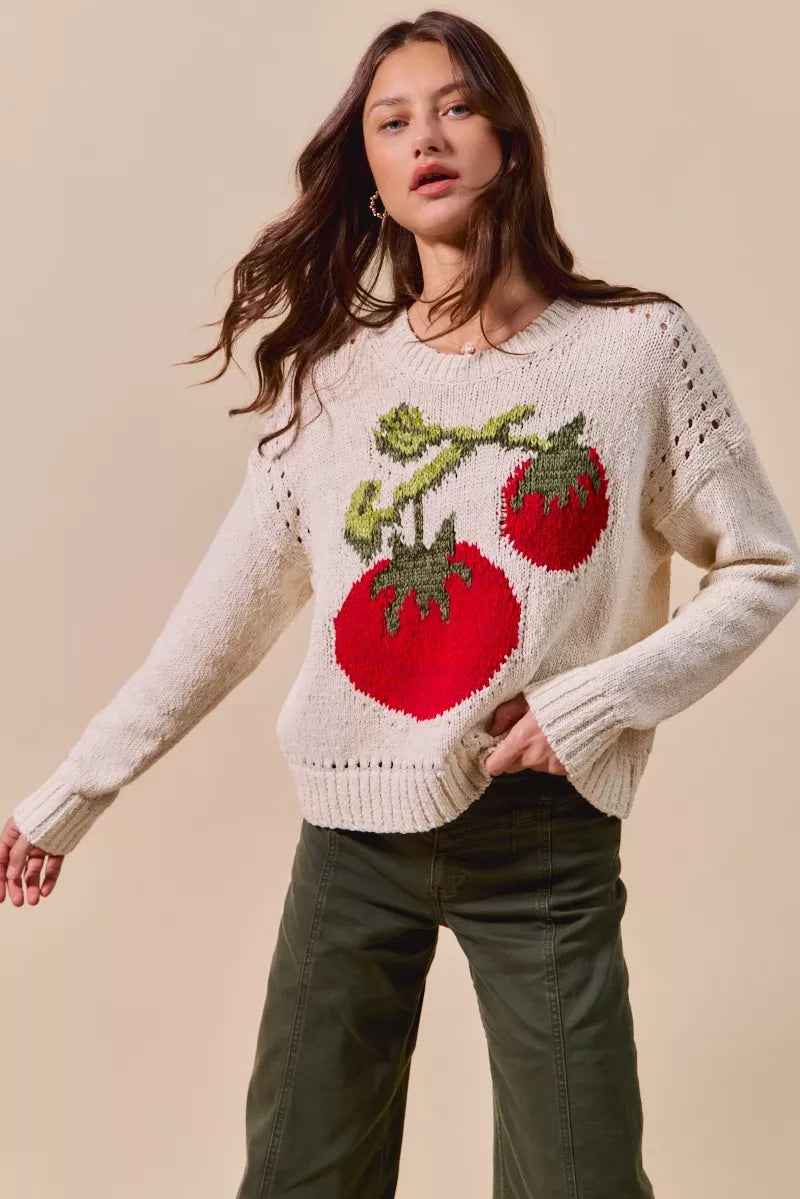 Tomato Vine Sweater – whimsical knit with red tomato design, round neck, ribbed cuffs, and eyelet details.