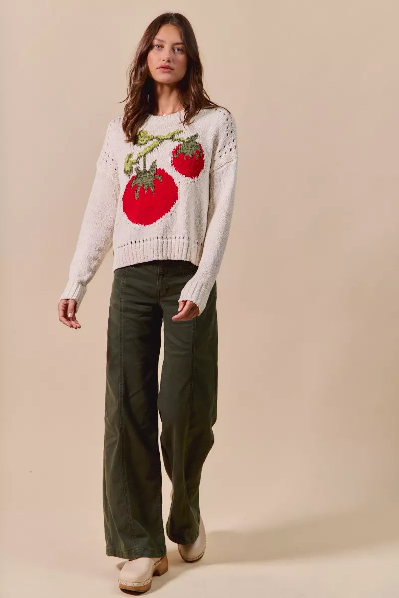 Tomato Vine Sweater – whimsical knit with red tomato design, round neck, ribbed cuffs, and eyelet details.