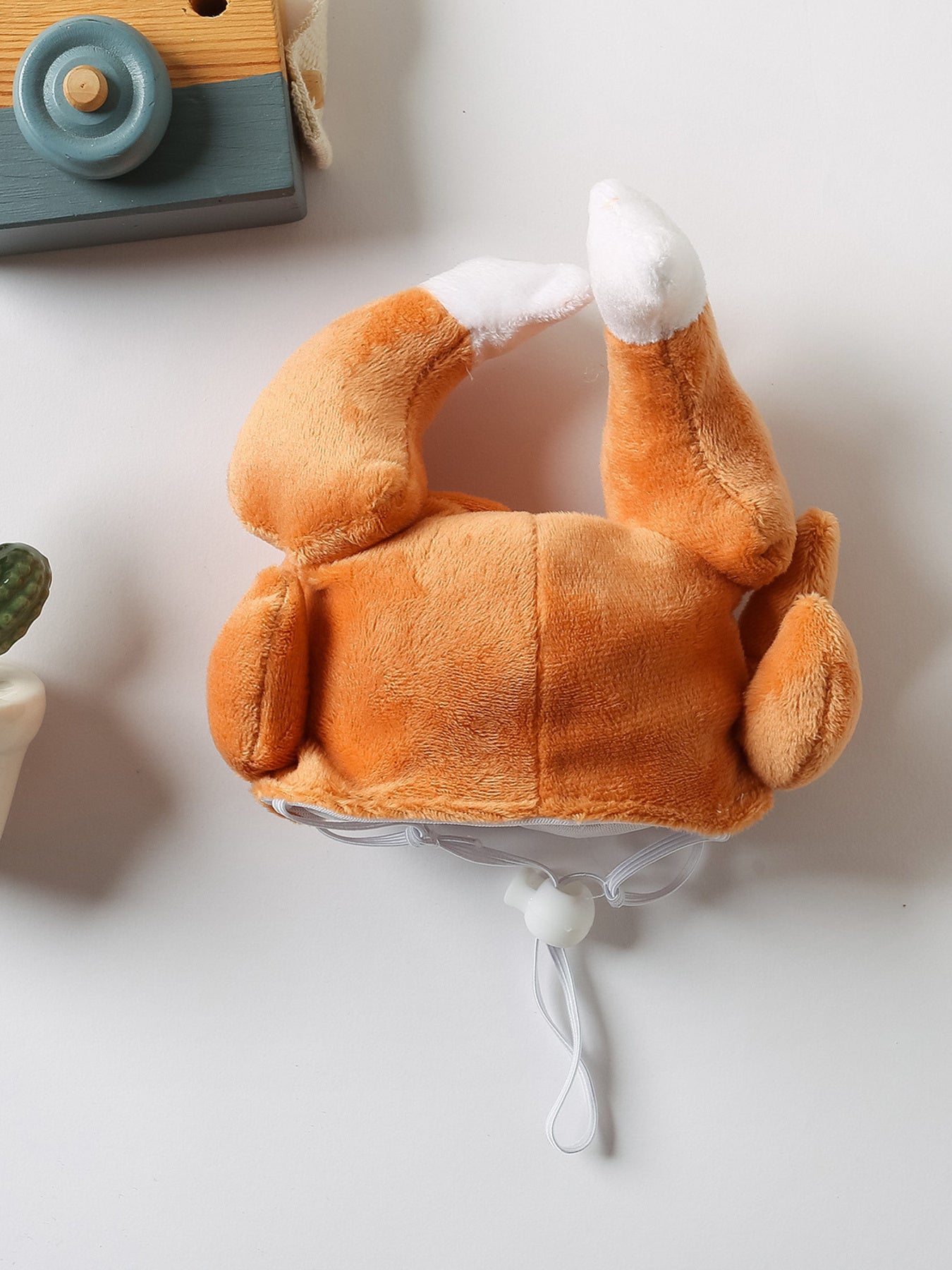 a plush turkey-shaped pet hat