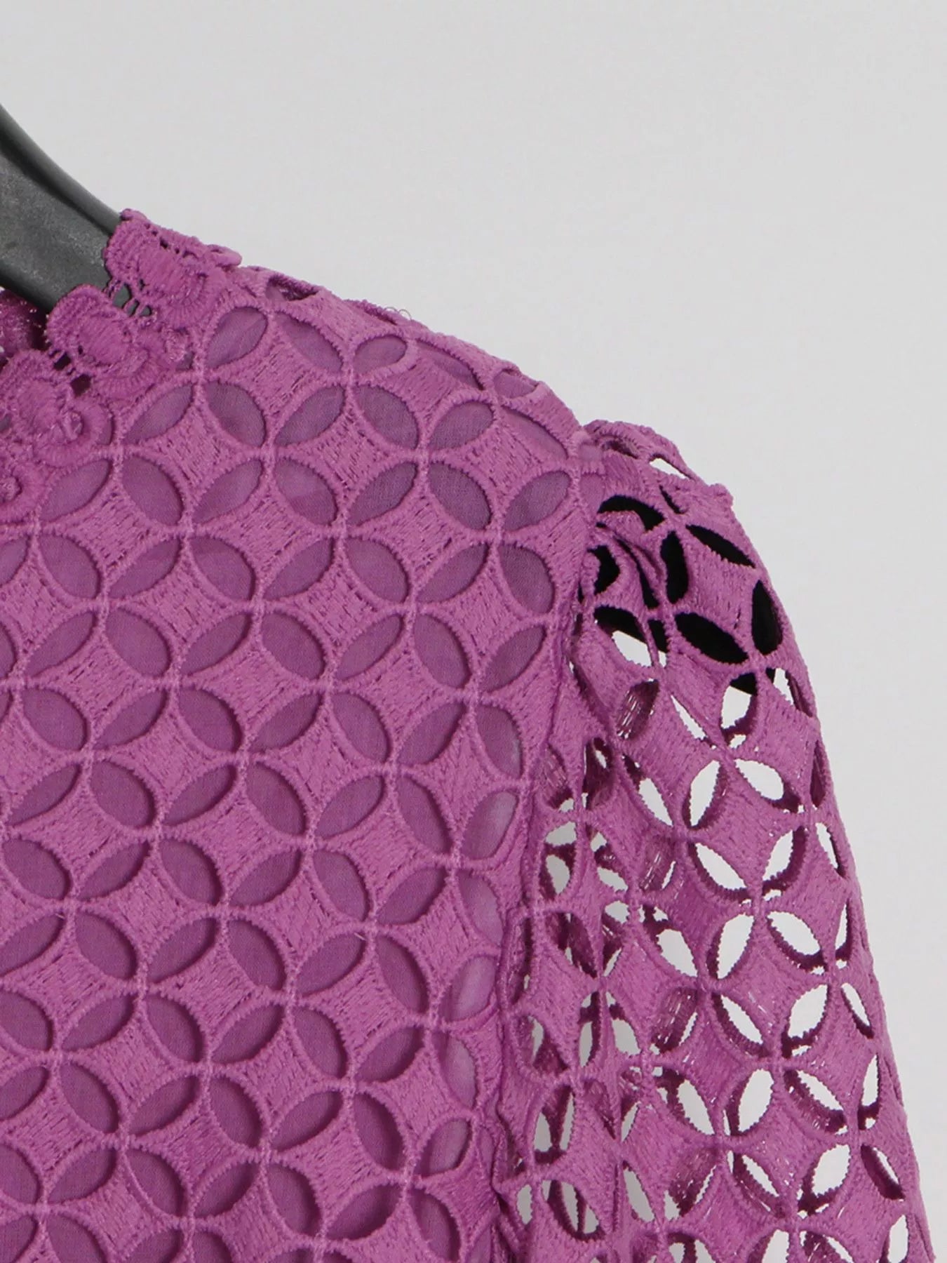 Model wearing the Violet Lace Cutout Midi Dress with long sheer balloon sleeves, high neckline, and geometric lace design, styled with white strappy heels.