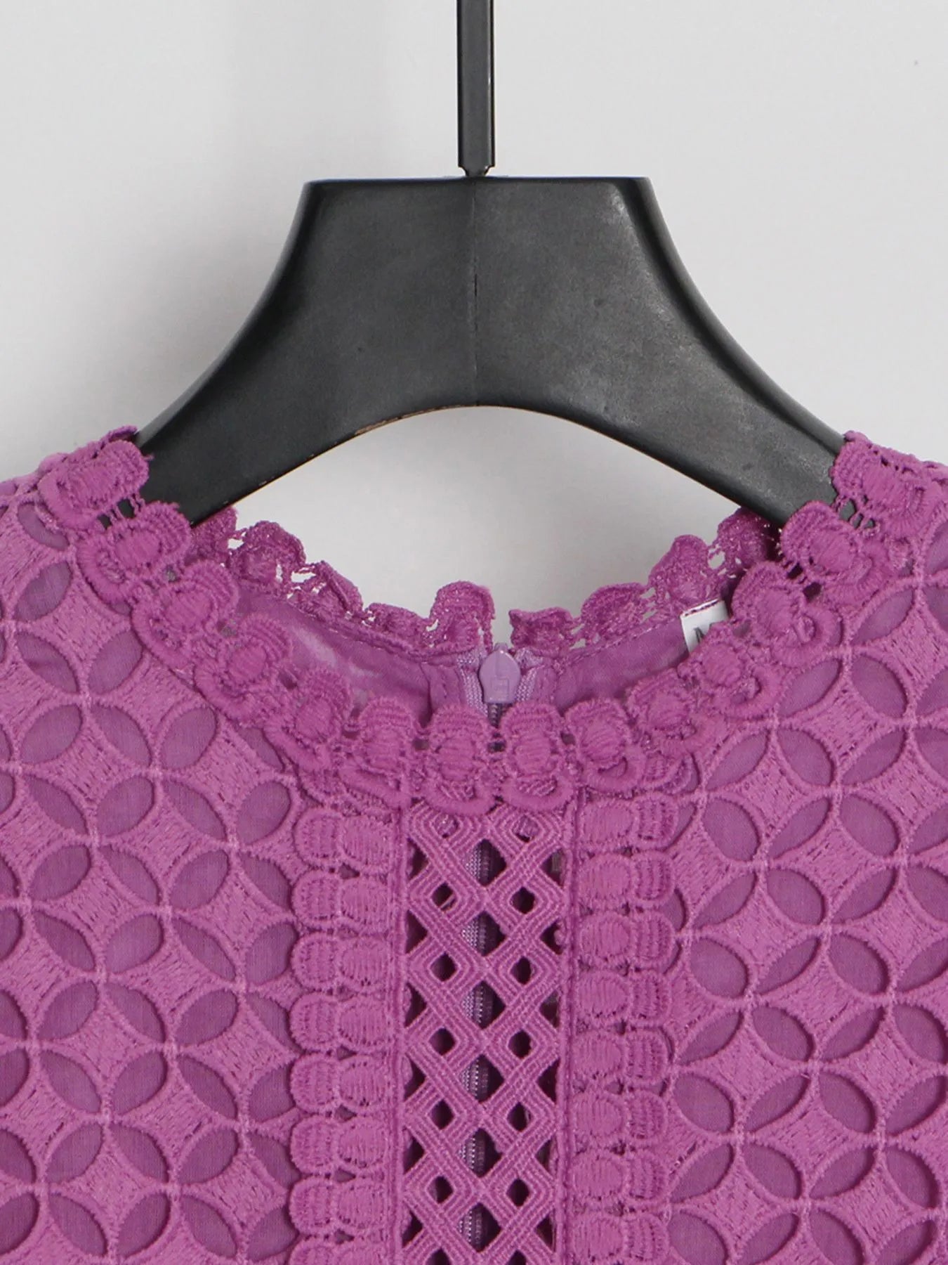 Model wearing the Violet Lace Cutout Midi Dress with long sheer balloon sleeves, high neckline, and geometric lace design, styled with white strappy heels.