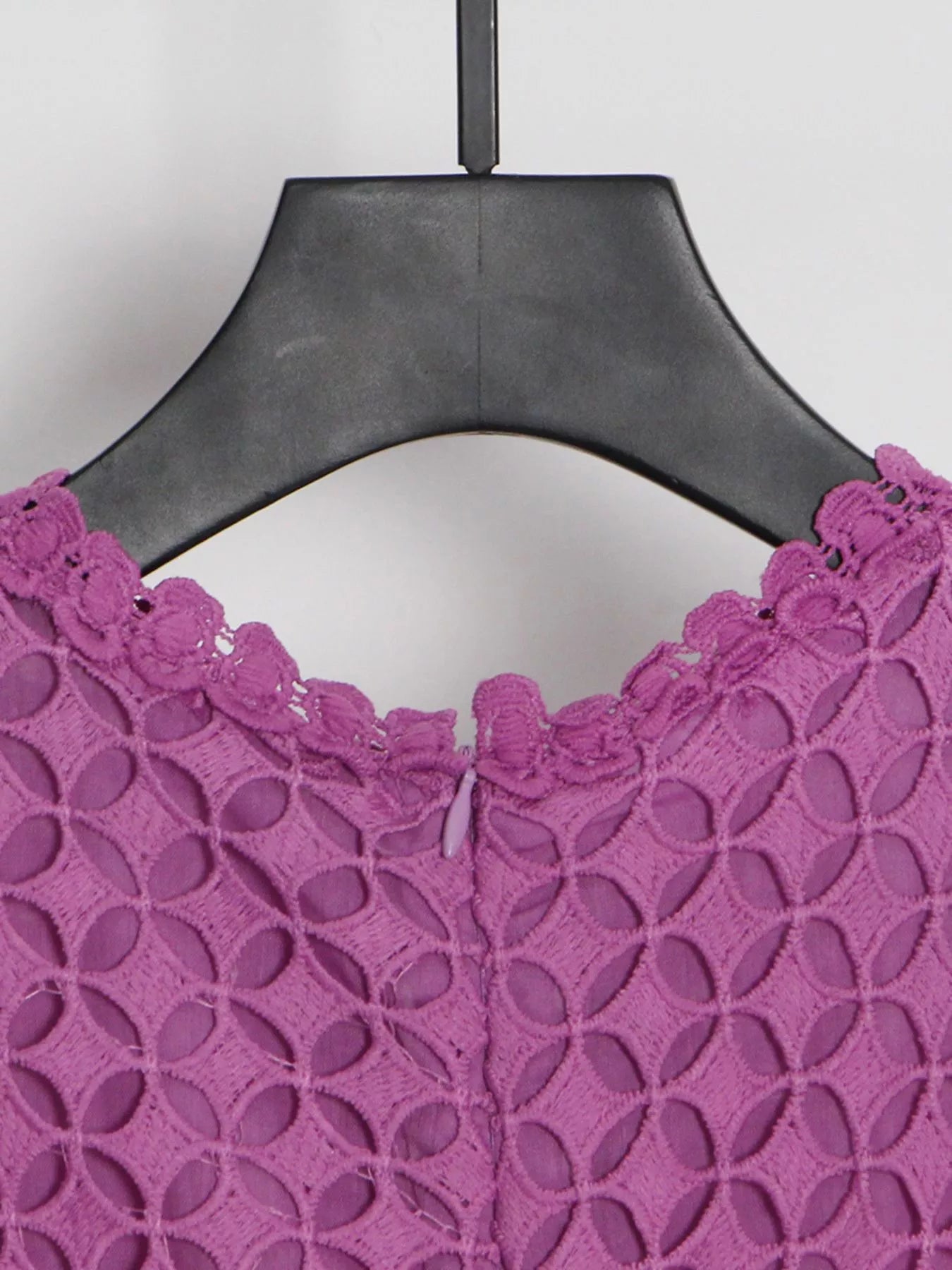 Model wearing the Violet Lace Cutout Midi Dress with long sheer balloon sleeves, high neckline, and geometric lace design, styled with white strappy heels.