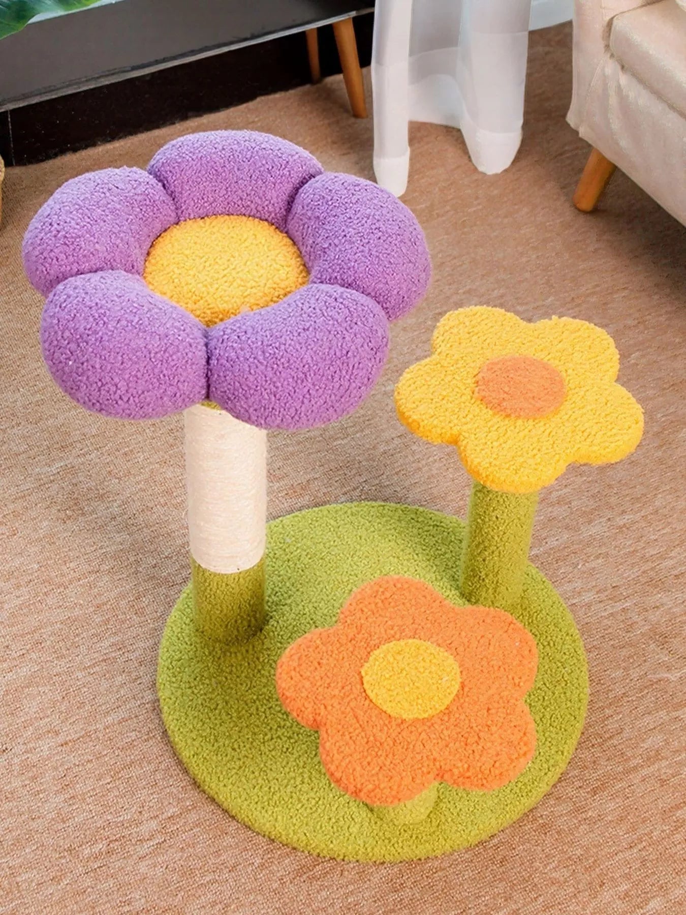 White cat lounging on colorful flower-shaped cat perch with scratching post