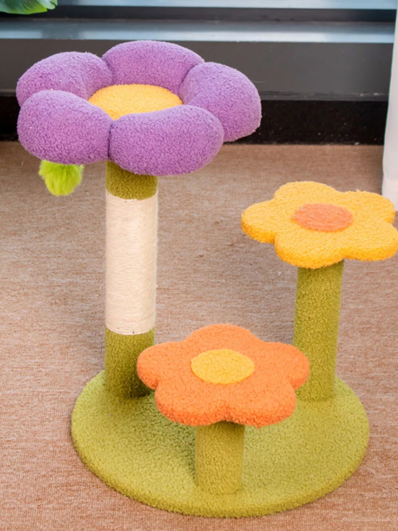 White cat lounging on colorful flower-shaped cat perch with scratching post