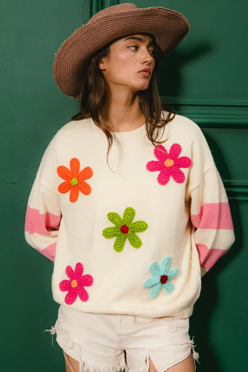 Whimsy Bloom Sweater by BiBi – oatmeal knit with colorful floral appliqués and striped sleeves.