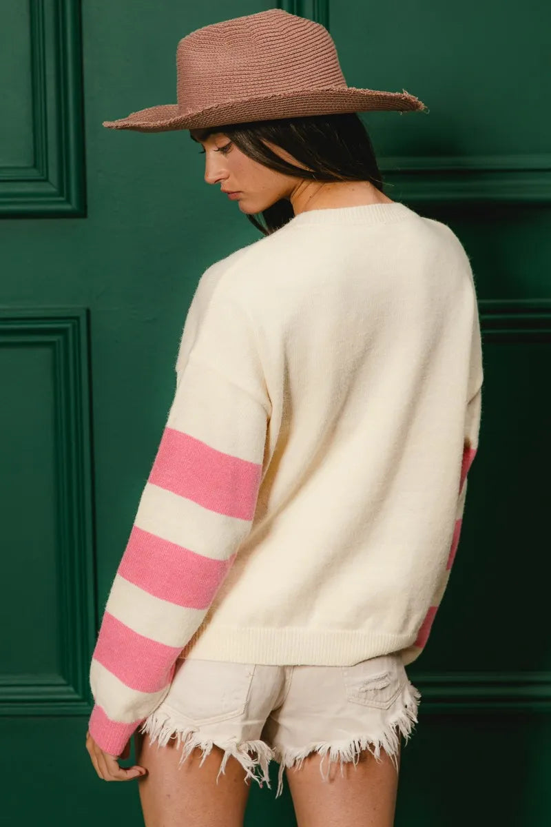 Whimsy Bloom Sweater by BiBi – oatmeal knit with colorful floral appliqués and striped sleeves.