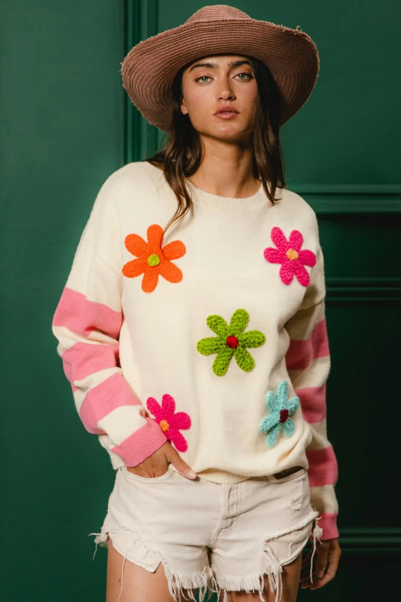 Whimsy Bloom Sweater by BiBi – oatmeal knit with colorful floral appliqués and striped sleeves.