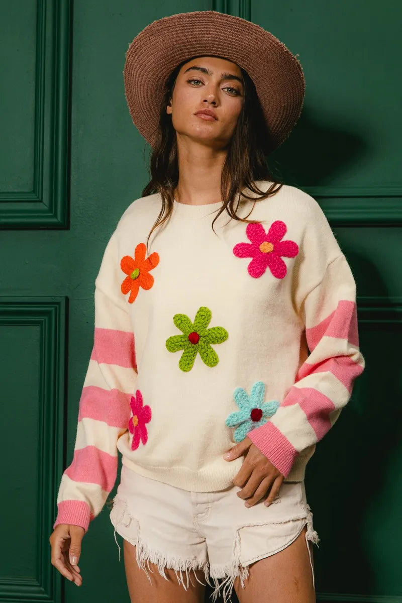 Whimsy Bloom Sweater by BiBi – oatmeal knit with colorful floral appliqués and striped sleeves.