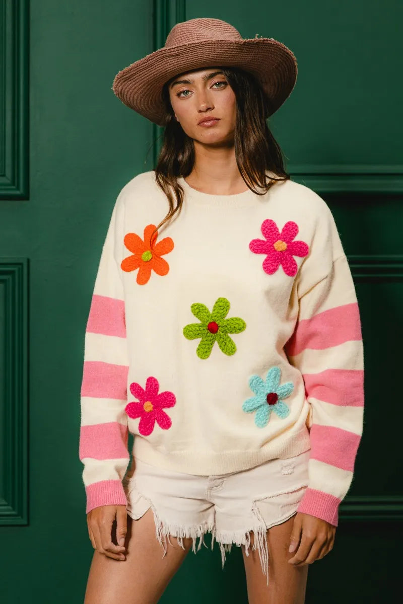 Whimsy Bloom Sweater by BiBi – oatmeal knit with colorful floral appliqués and striped sleeves.