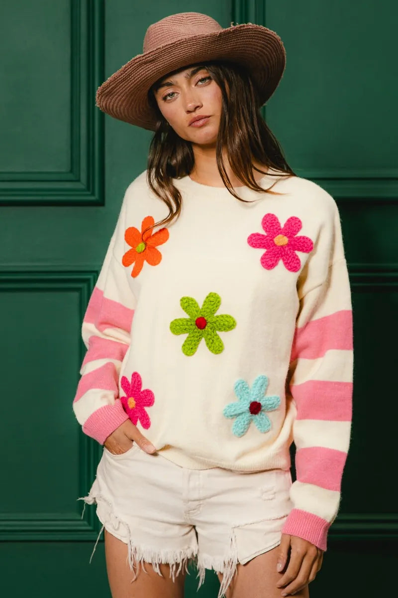 Whimsy Bloom Sweater by BiBi – oatmeal knit with colorful floral appliqués and striped sleeves.