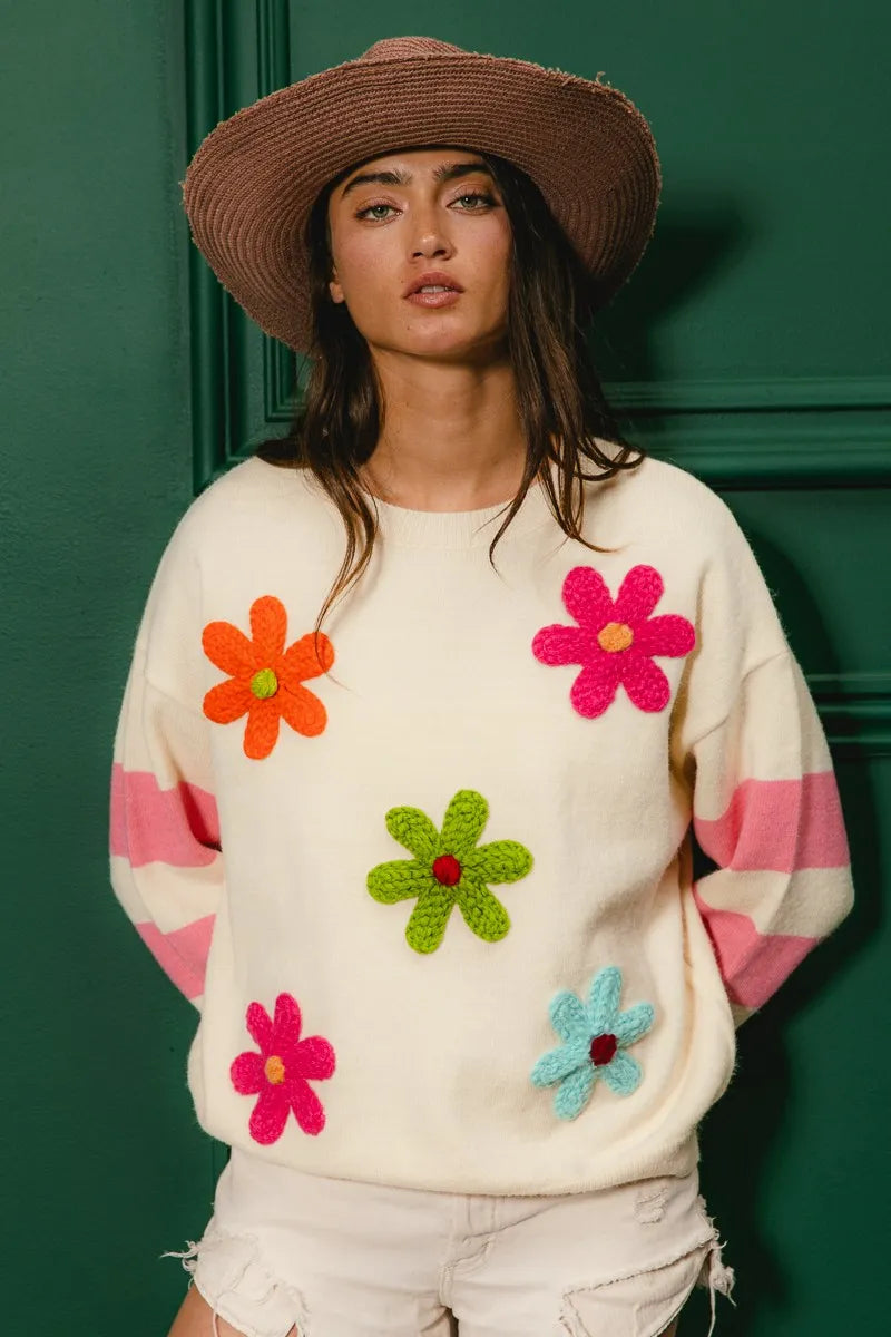 Whimsy Bloom Sweater by BiBi – oatmeal knit with colorful floral appliqués and striped sleeves.