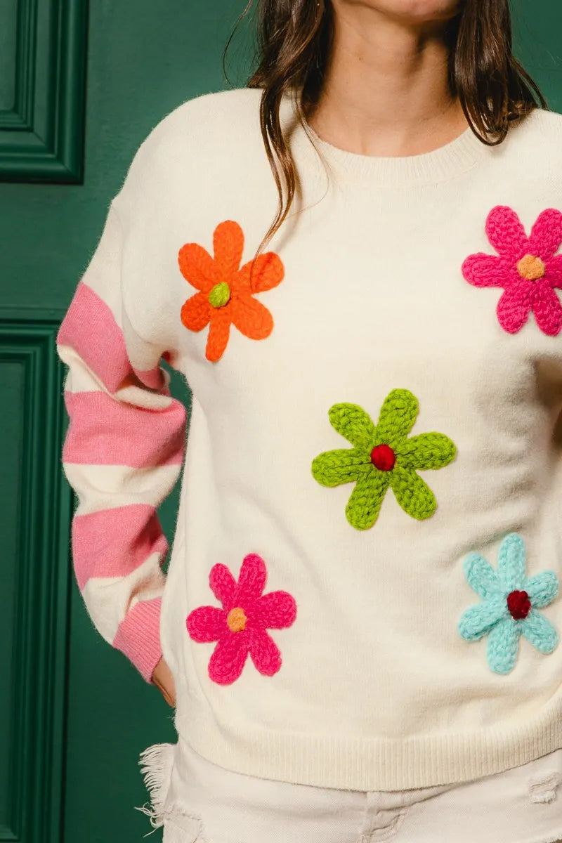 Whimsy Bloom Sweater by BiBi – oatmeal knit with colorful floral appliqués and striped sleeves.