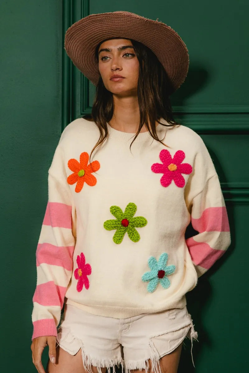 Whimsy Bloom Sweater by BiBi – oatmeal knit with colorful floral appliqués and striped sleeves.