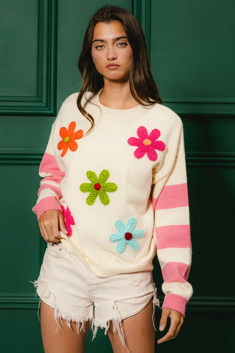 Whimsy Bloom Sweater by BiBi – oatmeal knit with colorful floral appliqués and striped sleeves.