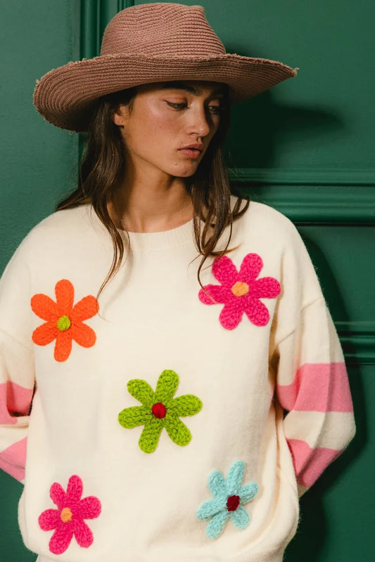 Whimsy Bloom Sweater by BiBi – oatmeal knit with colorful floral appliqués and striped sleeves.