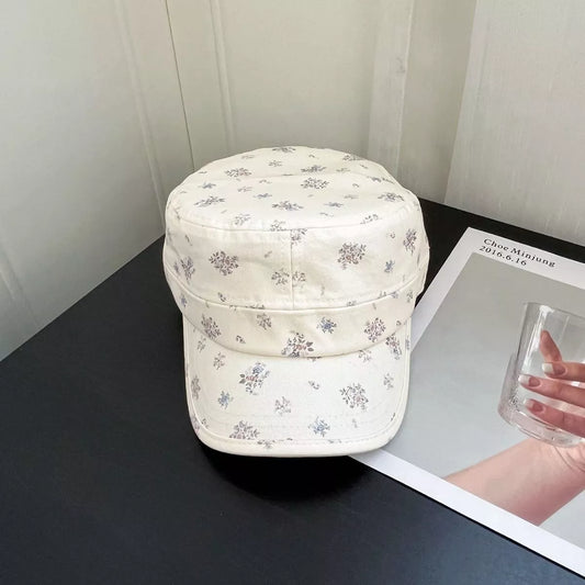 Cream cotton cadet cap with tiny floral print, structured brim, and soft vintage-inspired casual style.