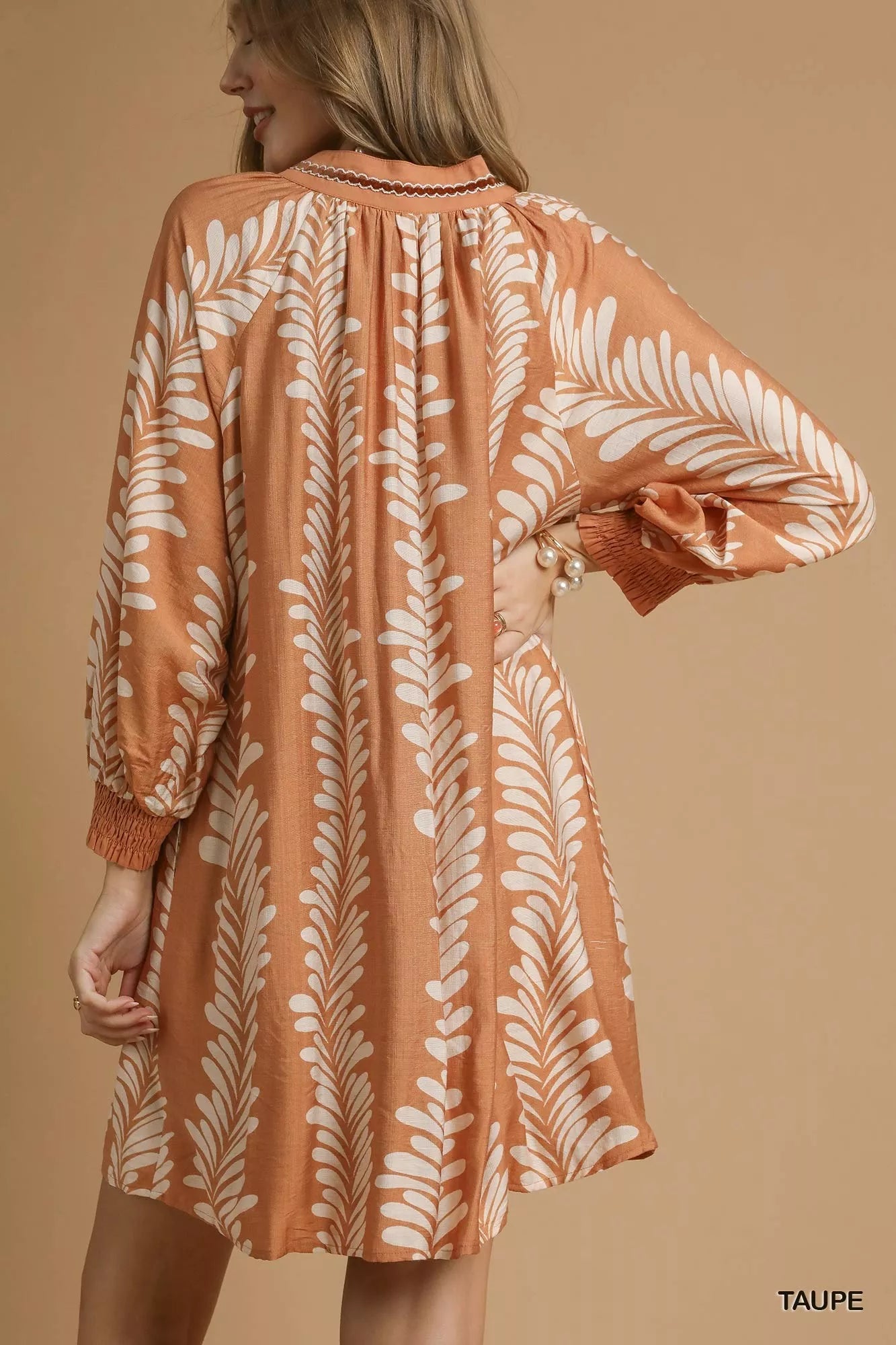 Whispering Leaves Taupe Mini Babydoll Dress with leaf print, notched neckline, and relaxed silhouette.