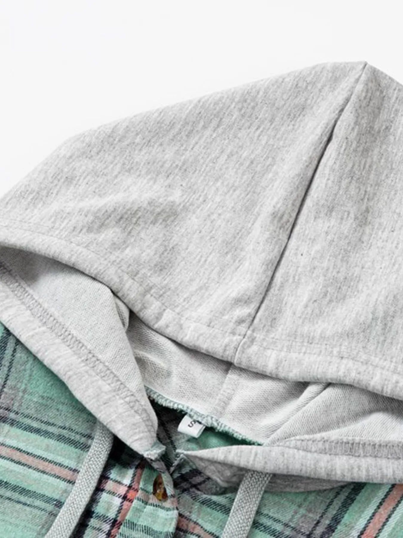 A green plaid flannel hoodie shirt with buttoned front and relaxed fit, perfect for cozy fall layering.