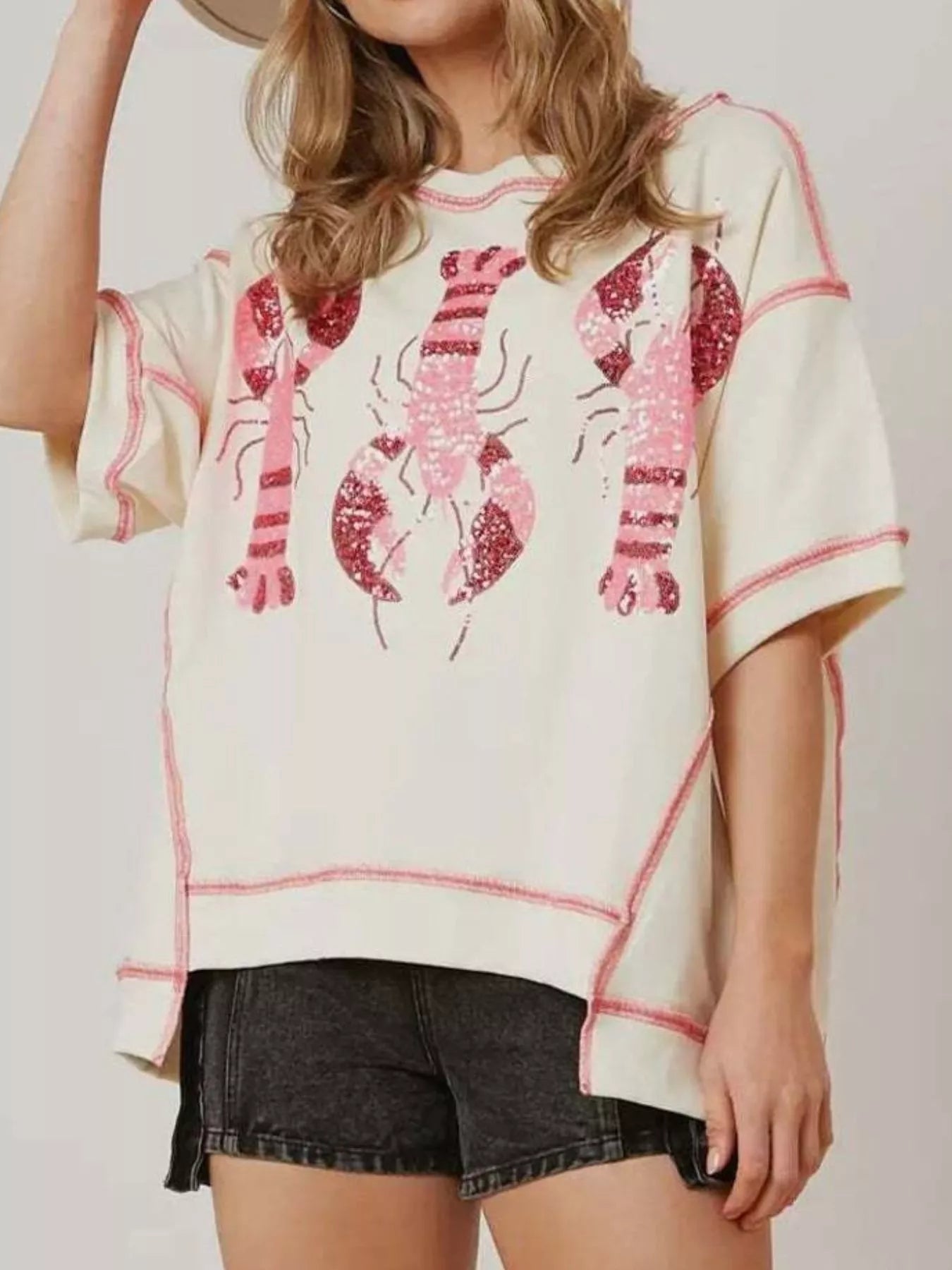 Oversized white tee with pink glitter lobster print and contrast stitching.