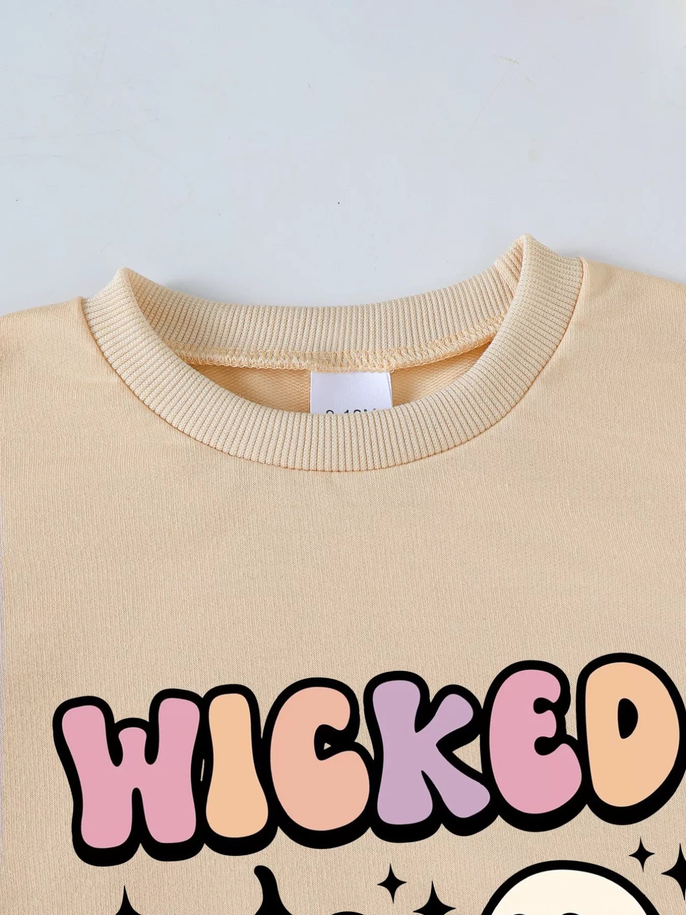 toddler halloween outfit with wicked cute pumpkin ghost sweatshirt and brown ribbed bell-bottom pants two-piece set