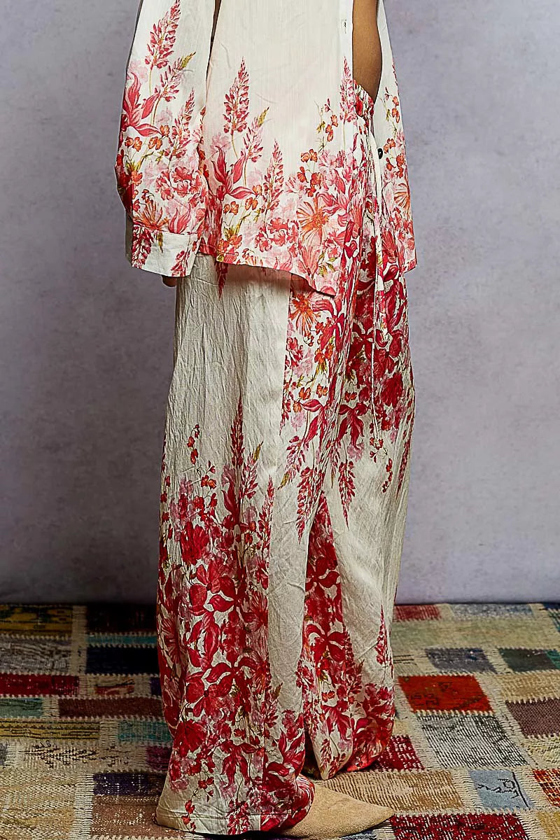 Floral printed wide leg pants with drawstring waist in red and cream tones, styled for a boho chic look.