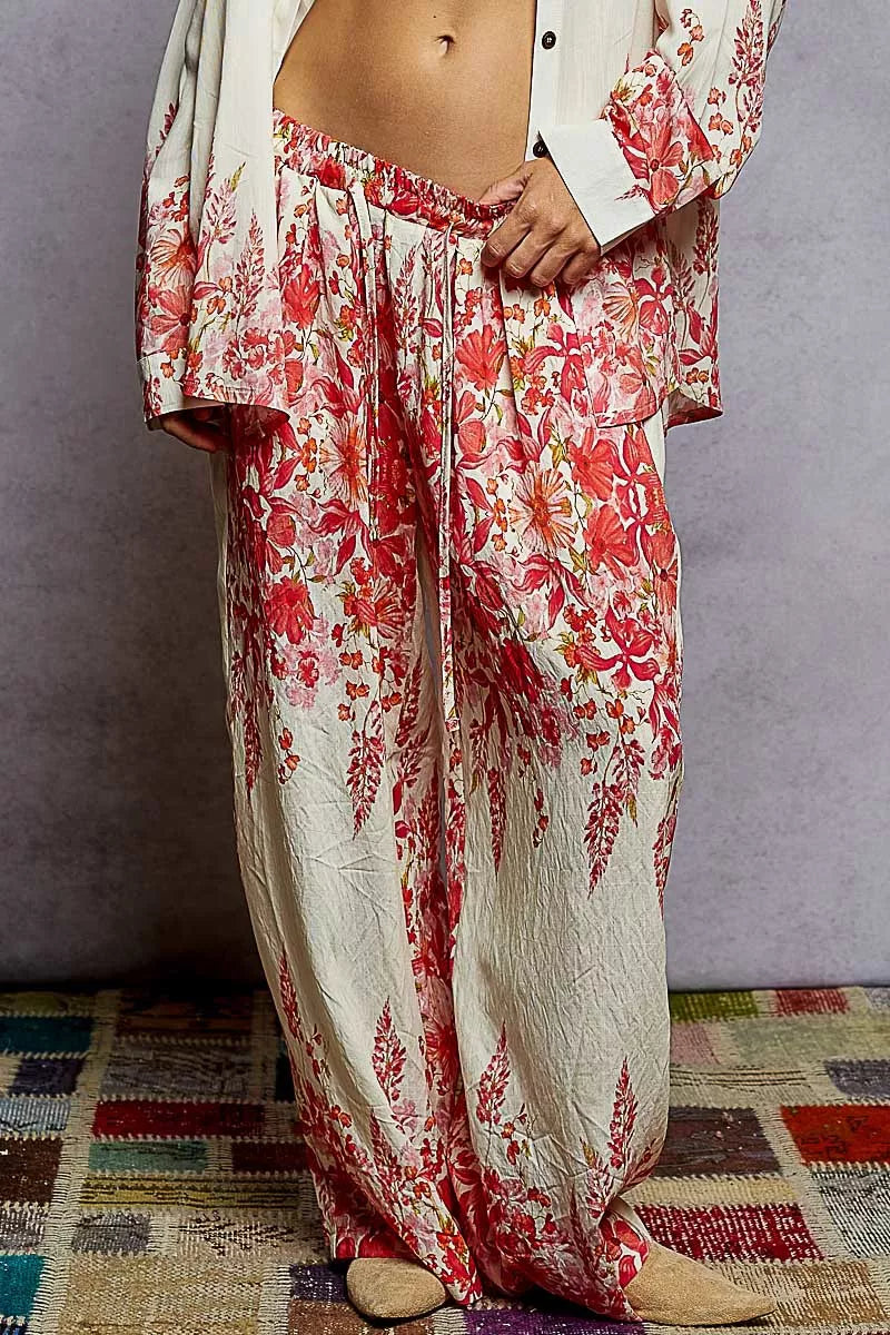 Floral printed wide leg pants with drawstring waist in red and cream tones, styled for a boho chic look.