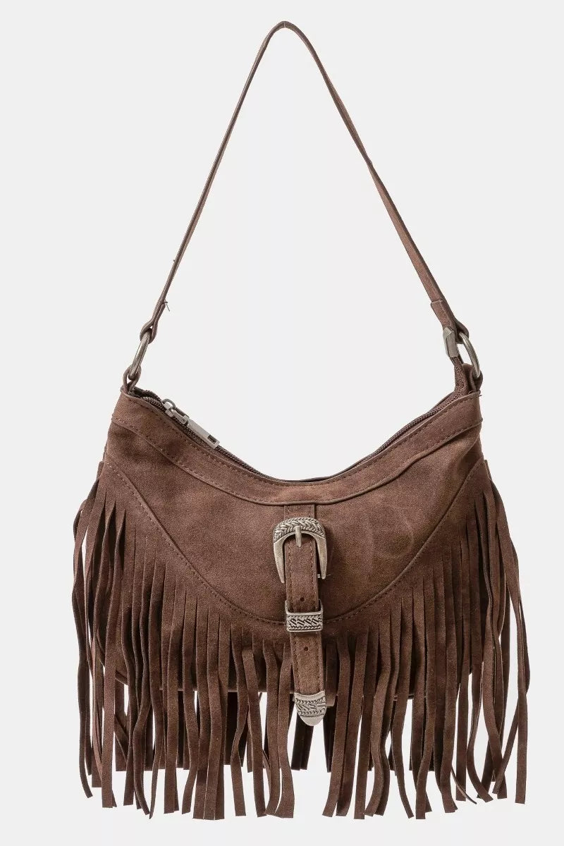 Brown faux suede shoulder bag with cascading fringe and vintage silver buckle detail, displayed with detachable strap — boho accessory from A Whimsical Affair.