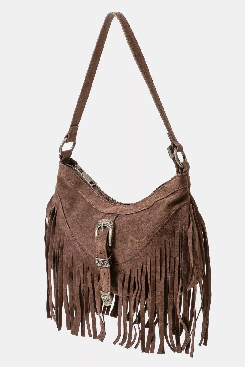 Brown faux suede shoulder bag with cascading fringe and vintage silver buckle detail, displayed with detachable strap — boho accessory from A Whimsical Affair.