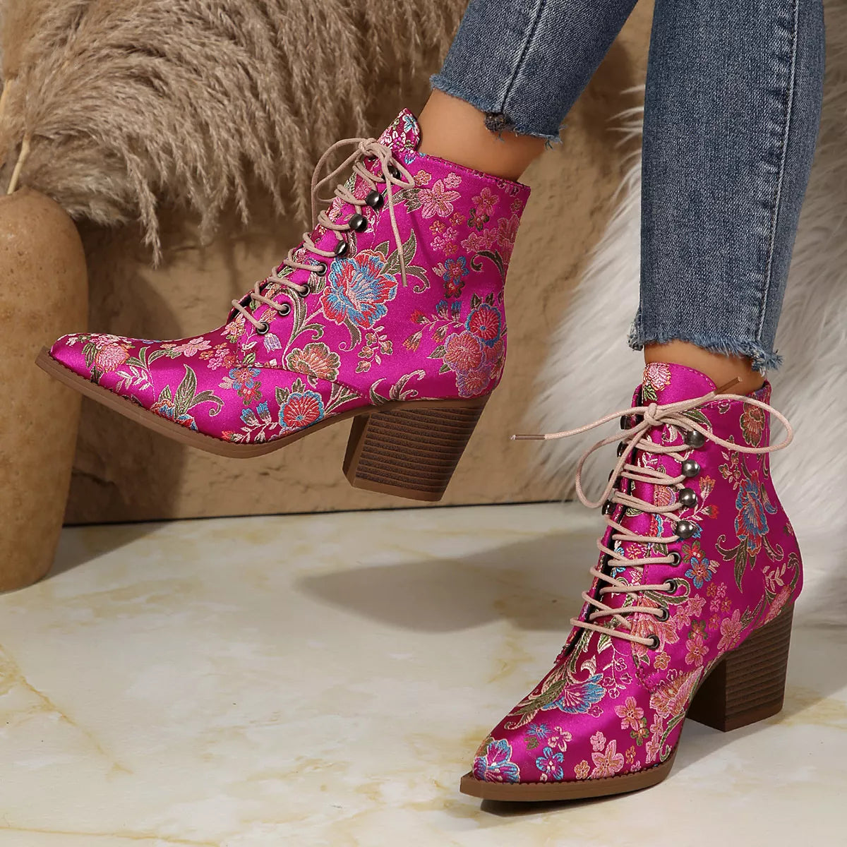Floral lace-up ankle boots with high heel and vintage-inspired pattern.