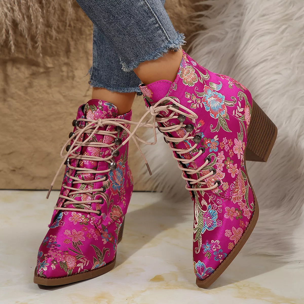 Floral lace-up ankle boots with high heel and vintage-inspired pattern.