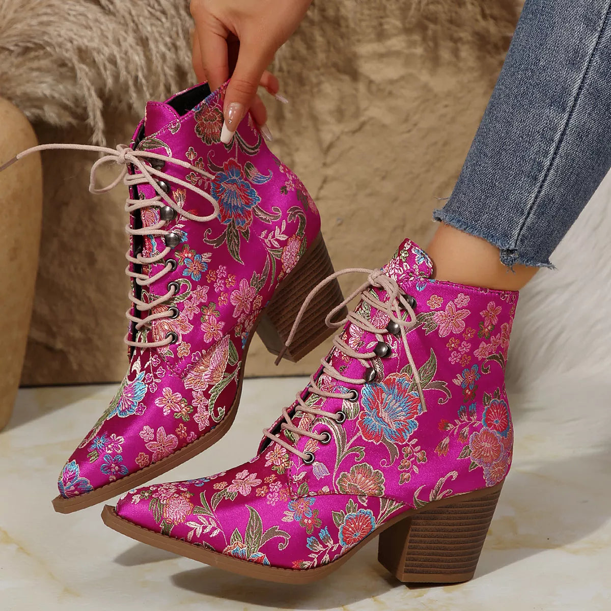 Floral lace-up ankle boots with high heel and vintage-inspired pattern.