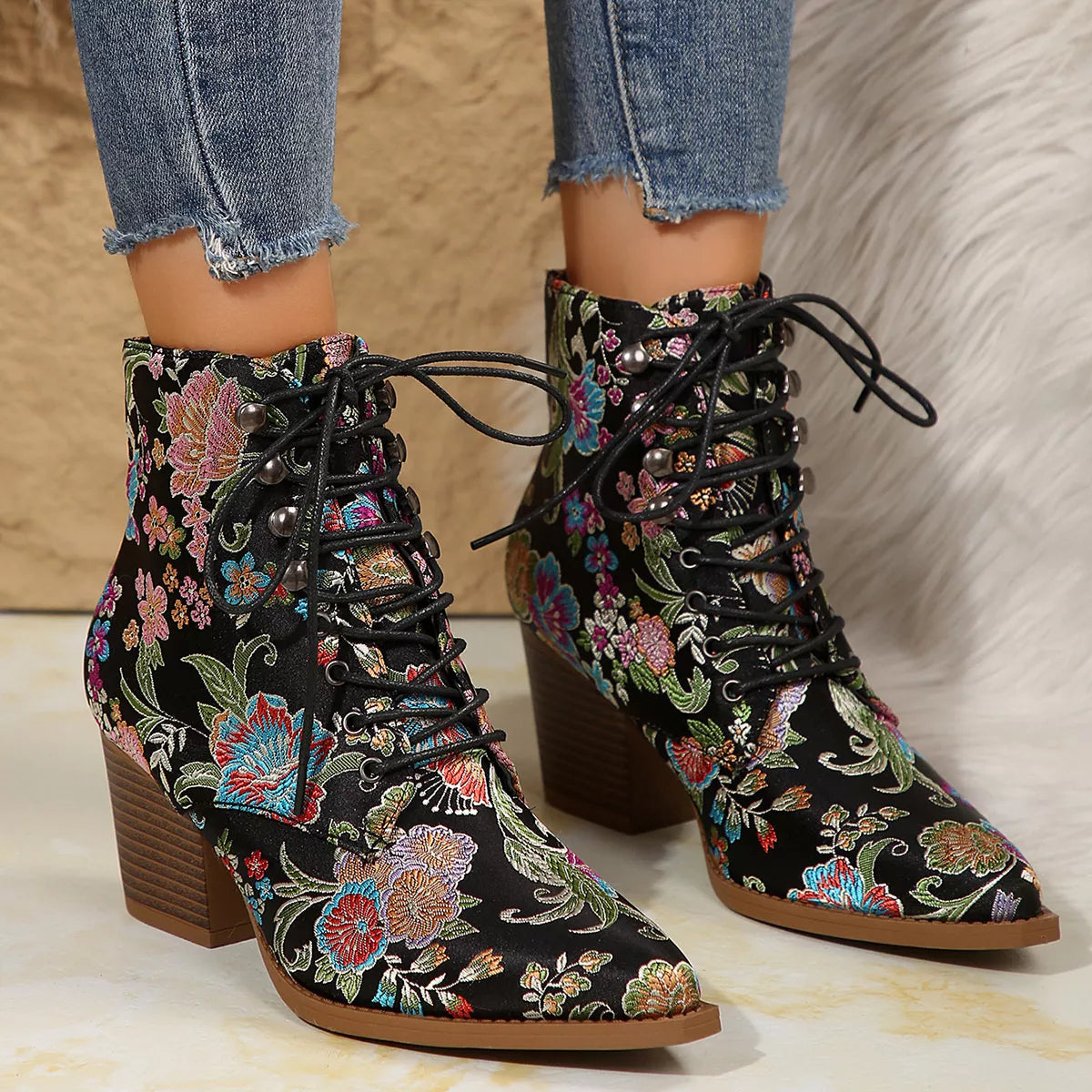 Floral lace-up ankle boots with high heel and vintage-inspired pattern.