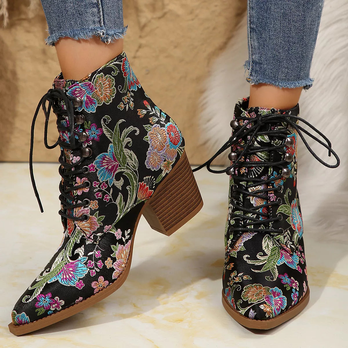 Floral lace-up ankle boots with high heel and vintage-inspired pattern.