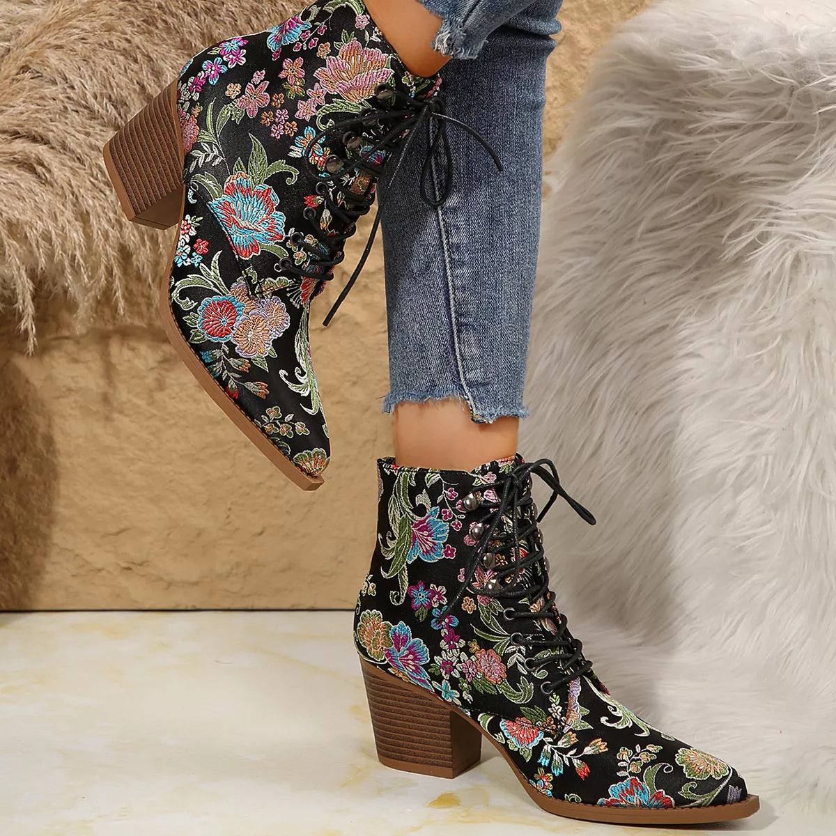 Floral lace-up ankle boots with high heel and vintage-inspired pattern.