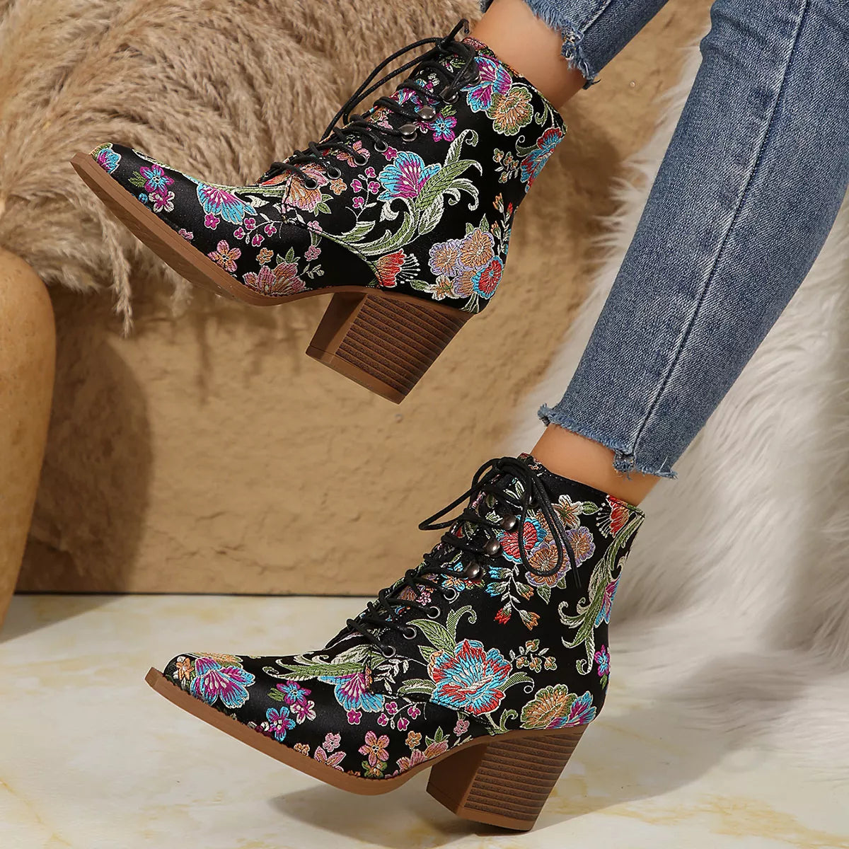 Floral lace-up ankle boots with high heel and vintage-inspired pattern.