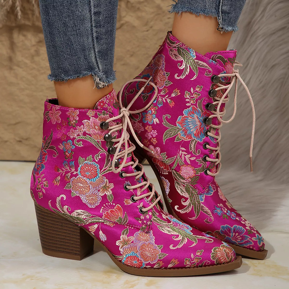 Floral lace-up ankle boots with high heel and vintage-inspired pattern.