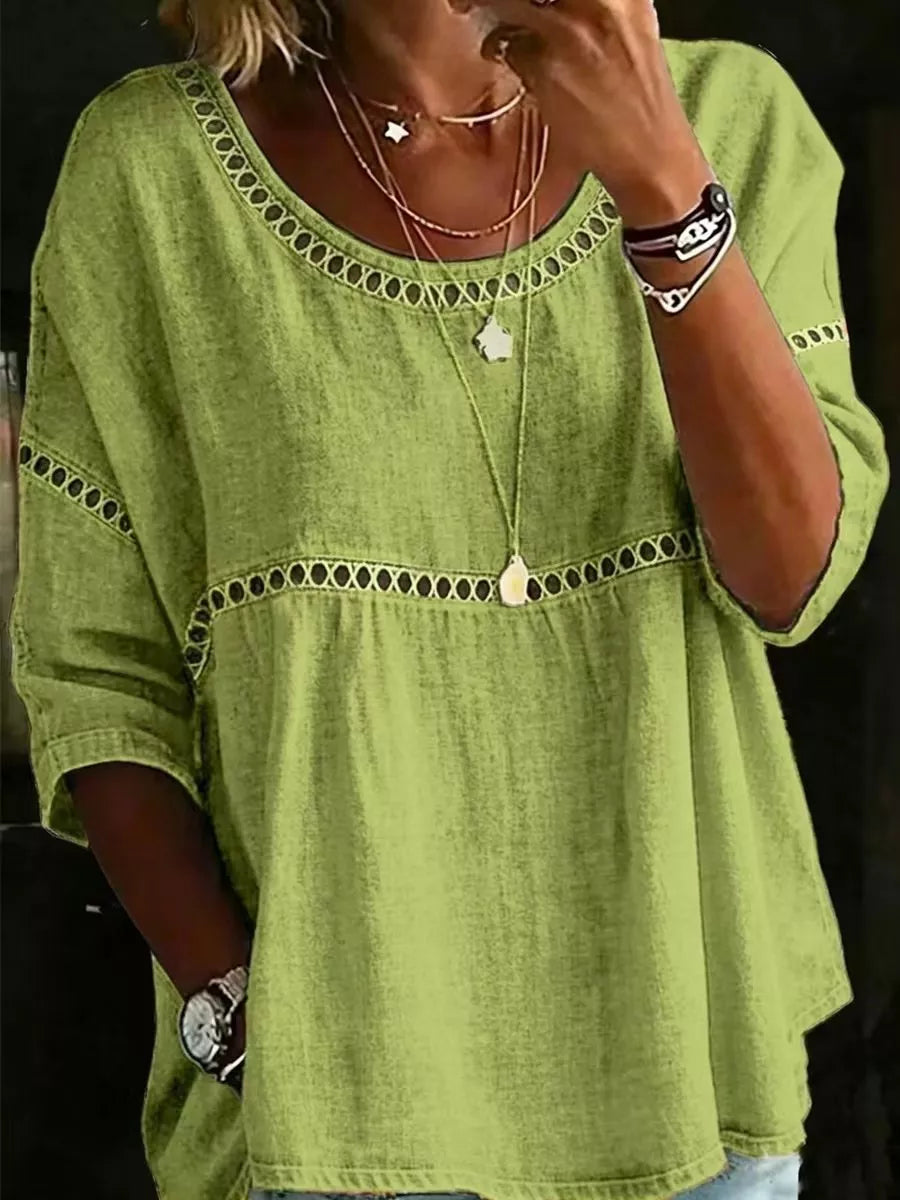 Flowy boho blouse with lace detail, relaxed fit, three-quarter sleeves, lightweight woven fabric, and vintage-inspired styling.
